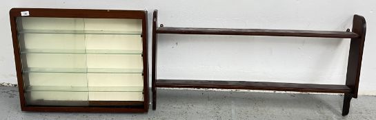 A WALL HANGING COLLECTORS CABINET WITH GLASS SLIDING DOORS AND SHELVES,