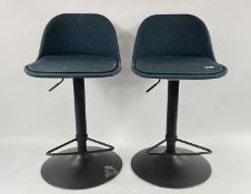 A PAIR OF MODERN BLUE FABRIC RISE AND FALL BREAKFAST STOOLS (SOME DISCOLOURATION TO SEAT CUSHIONS).