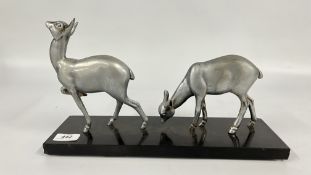 AN ART DECO ALUMINIUM DEER STUDY MOUNTED ON A POLISHED HARD STONE BASE BEARING SIGNATURE IRENEE
