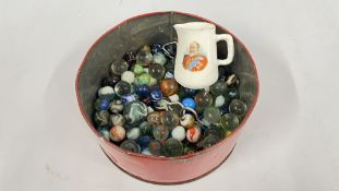A VINTAGE TIN CONTAINING A COLLECTION OF ASSORTED VINTAGE GLASS MARBLES + A VINTAGE ROYAL DOULTON