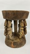 AN AFRICAN DRUM STYLE CARVED STOOL DEPICTING FERTILITY FIGURES, H 44 X DIAM 34.5CM.