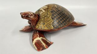 A DECORATIVE HAND CARVED WOODEN INDONESIAN STYLE TURTLE, FEATURING A TRADITIONAL BATIK PRINT DESIGN,