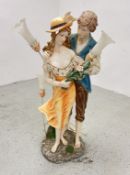 A LARGE COMPOSITE FLOOR STANDING LAMP WITH GLASS SHADE DEPICTING YOUNG LOVERS, H 110CM.