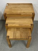 A NEST OF THREE GRADUATED MODERN SOLID LIGHT OAK OCCASIONAL TABLES, W 56 X D 38 X H 53CM.