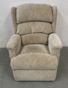 A CREAM PATTERNED UPHOLSTERED ELECTRIC RISE AND RECLINE EASY CHAIR - SOLD AS SEEN.