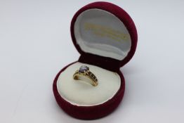 A MOONSTONE AND SAPPHIRE DRESS RING STAMPED 750.