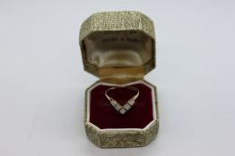 A 9CT GOLD OPAL SET WISHBONE RING IN A VINTAGE BOX.