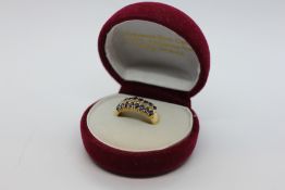 AN ELABORATE DRESS RING SET WITH BLUE SAPPHIRES AND A ROW DIAMONDS, STAMPED 750.