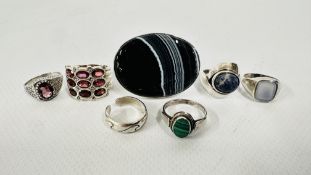 A GROUP OF 7 ASSORTED SILVER STONE SET DRESS RINGS.