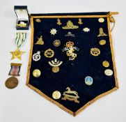 CLOTH HANGING CONTAINING ASSORTED MILITARY RELATED BADGES AND BUTTONS INCLUDING ROYAL ARMY SERVICE,