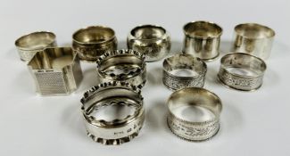 A GROUP OF 11 SILVER NAPKIN RINGS, VARIOUS DATES AND MAKERS.