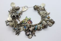 A SILVER CHARM BRACELET WITH MAINLY SILVER CHARMS ATTACHED.