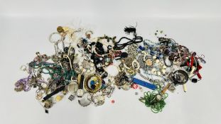 AN EXTENSIVE GROUP OF ASSORTED COSTUME JEWELLERY, BEADED NECKLACES, BANGLES, EARRINGS AND WATCHES.