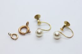 A PAIR OF 9CT GOLD SCREW BACK SIMULATED PEARL EARRINGS AND TWO YELLOW METAL CLASPS.