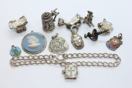A SILVER CHARM BRACELET WITH UNATTACHED SILVER AND WHITE METAL CHARMS.