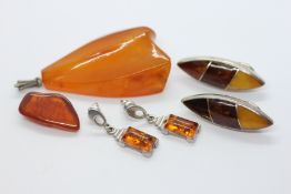 TWO PAIRS OF MODERN AMBER TYPE EARRINGS, THE CLIP ON EXAMPLES MARKED 925 + A AMBER TYPE PENDANT,