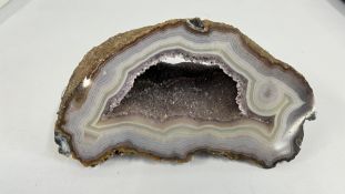 AN AMETHYST GEODE ROCK CRYSTAL SAMPLE.