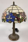 A REPRODUCTION TIFFANY STYLE TABLE LAMP, THE SHADE DECORATED WITH FLOWERS AND VINES, HEIGHT 43CM.