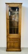 AN ERCOL FULL HEIGHT DISPLAY CABINET WITH CUPBOARD TO BASE.