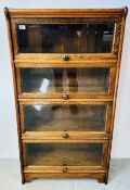 AN OAK GLOBEWERNICKE STYLE BOOKCASE WITH FOUR GLAZED UP AND OVER DOORS, W 71CM, D 32CM, H 135CM.