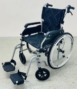 A SIRIUS CARE CO FOLDING WHEELCHAIR.