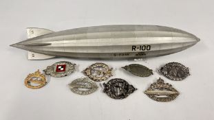 A GROUP OF REPRODUCTION GERMAN BADGES AND A MODEL AIRSHIP.