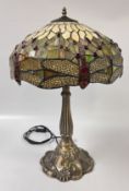 A LARGE REPRODUCTION TIFFANY STYLE TABLE LAMP, THE LEADED SHADE DECORATED WITH DRAGONFLIES,