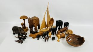 A GROUP OF WOODEN ANIMAL CARVINGS TO INCLUDE A MODEL SAILING BOAT AND TOADSTOOL.
