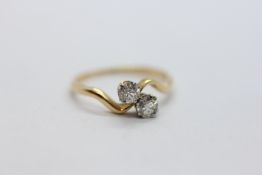 AN 18CT YELLOW GOLD TWO STONE DIAMOND RING, THE SPREAD OF EACH BRILLIANT CUT STONE APPROX 3.