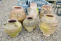 6 LARGE TERRACOTTA GRECIAN STYLE GARDEN URNS, LARGEST 82CM TALL.
