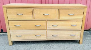 A MODERN SOLID LIGHT OAK SEVEN DRAWER CHEST, W 146CM, D 41CM, H 76CM.