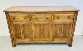 AN ERCOL THREE DOOR, THREE DRAWER SIDEBOARD, W 145 X D 52 X H 86CM.