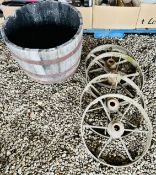 4 X VINTAGE CAST IRON WAGON WHEELS ALONG WITH RECLAIMED WOODEN BARREL PLANTER, WIDTH 65CM.