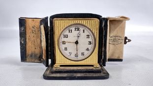 A VINTAGE ART DECO ZENITH TRAVEL CLOCK IN A FITTED LEATHER CASE MARKED REID & SONS A/F.