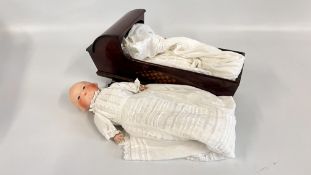 A VINTAGE MAHOGANY MARQUETRY INLAID ROCKING DOLL'S CRIB + A VINTAGE GERMAN DOLL BISQUE HEAD AND