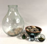 A LARGE GLASS CARBOY (RIM CHIP) + A BOWL OF ASSORTED URCHIN FOSSILS & 3 ART GLASS PAPERWEIGHTS.