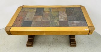 AN OAK AND TILE TOP HEAVILY CONSTRUCTED COFFEE TABLE.
