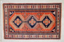 A PERSIAN SIRJAN STYLE RUG ON A RED GROUND, L 195CM X W 106CM.