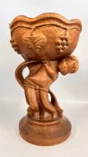 A CARVED WOODEN CENTRE PIECE / STATUE FEATURING A CHERUB / BOY HOLDING A FRUIT BOWL DECORATED WITH