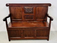 A BESPOKE STAINED PINE SETTLE WITH HINGED SEAT.