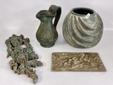 A RESIN PLAQUE DEPICTING CHERUBS,