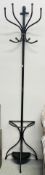 A DEMI LUNE METAL CRAFT COAT AND STICK STAND.