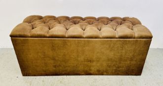 A MODERN BUTTON BACK TAN SUEDETTE OTTOMAN.