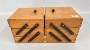 A CANTILEVER ACTION SEWING BOX AND CONTENTS TO INCLUDE THREADS AND HABERDASHERY ACCESSORIES.