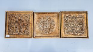 THREE HAND CARVED WOODEN PANELS, EACH APPROXIMATELY 30 INCH SQUARE.