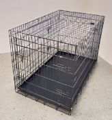 A LARGE FOLDING DOG CRATE.