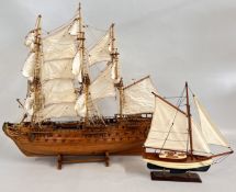 A LARGE WOODEN MODEL OF A BATTLE SHIP, REQUIRES ATTENTION + A SMALLER YACHT EXAMPLE.