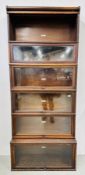A SIX SECTION GLOBE WERNICKE BOOKCASE BEARING ORIGINAL MAKER'S LABEL, ONE LACKING GLASS DOOR.