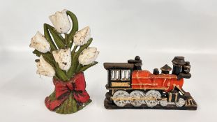 TWO CAST IRON DOOR STOPS INC TRAIN AND A FLOWER BOUQUET.
