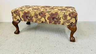 A REPRODUCTION UPHOLSTERED DOUBLE FOOTSTOOL STANDING ON BALL AND CLAW FOOT (UPHOLSTERY STAINED AND